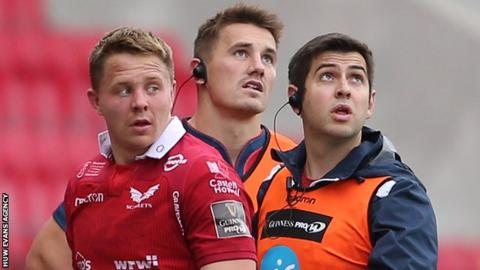 James Davies watches the action with brother Jonathan as he leaves the field with a medic