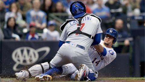 Victor Caratini #7 of the Chicago Cubs tags out Hernan Perez #14 of the Milwaukee Brewers at home plate in the second inning at Miller Park