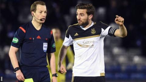 Willie Collum is questioned by Aberdeen defender Graeme Shinnie
