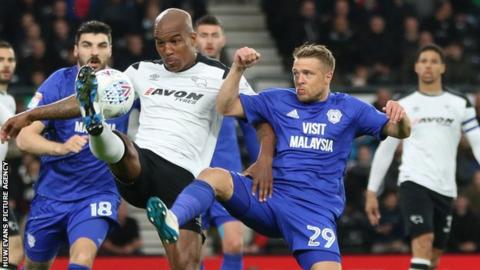 Andre Wisdom of Derby County and Jamie Ward of Cardiff City compete for the ball