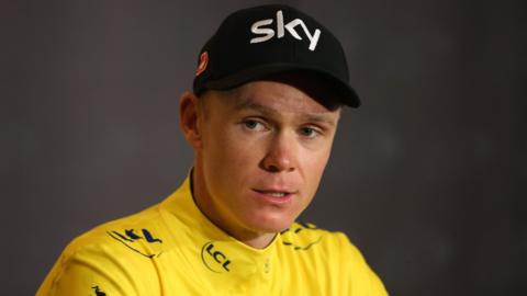 Chris Froome addresses the media while wearing the yellow jersey at the Tour de France