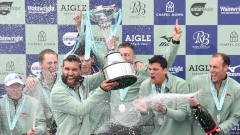 The Cambridge University Boat Club Blue Boat Crew celebrates after winning the Men's Boat Race