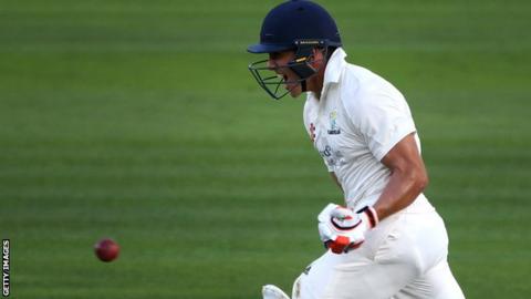 Kiran Carlson celebrates scoring a century for Glamorgan against Essex