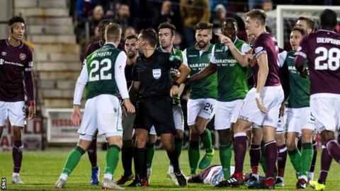 Hearts and Hibernian players with referee Andrew Dallas