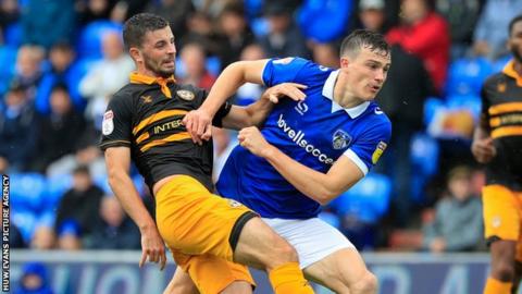 Newport County forward Padraig Amond (9) tries an effort on goal but it goes wide