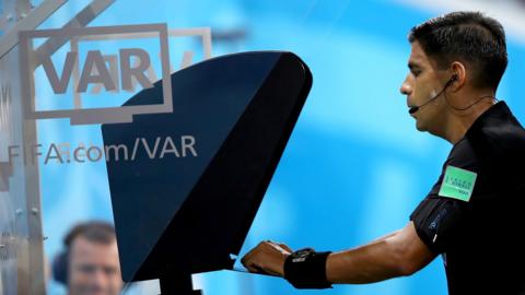 Referee watches the VAR screen