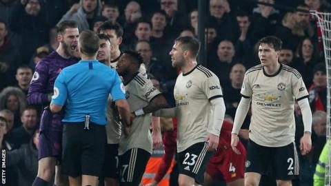 Manchester United keeper David De Gea confront referee Craig Pawson during his side's defeat at Liverpool