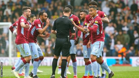 Aston Villa fans surround the referee