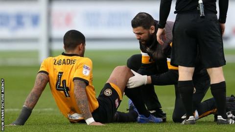 Newport midfielder Joss Labadie received treatment on his knee before being withdrawn against Forest Green