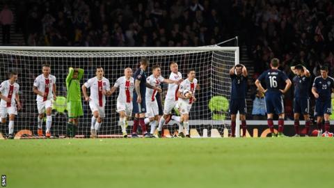 Poland celebrate while Scotland come to terms with what has just happened in the final seconds of the match