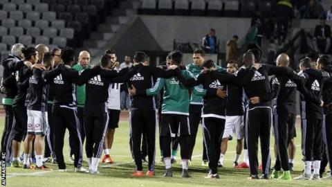 Al Masry players holding a moments silence