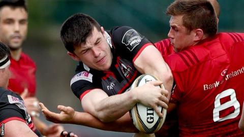 Edinburgh's Blair Kinghorn tries to escape the attention of Munster number eight CJ Stander