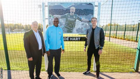 Joe Hart stands by his mosaic at the training ground