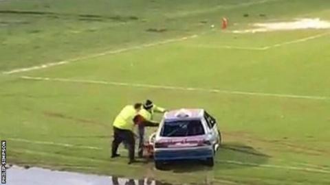 Stewards attending to a stock car at the 2018 New Year's Day Raceway at the Ballymena Showgrounds
