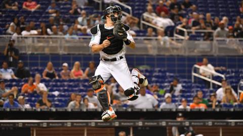 Miami, United States, 23 July: JT Realmuto of the Miami Marlins attempts to catch a throw from the outfield during the seventh inning of their match against the Atlanta Braves at Marlins Park. (Photo by Mark Brown/Getty Images)