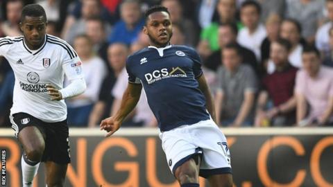 Mahlon Romeo of Millwall is pursued by Fulham winger Ryan Sessegnon
