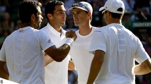 Jean-Julien Rojer of the Netherlands, left, and Horia Tecau of Romania, second left, win the men's doubles final against Jamie Murray of Britain and John Peers of Australia