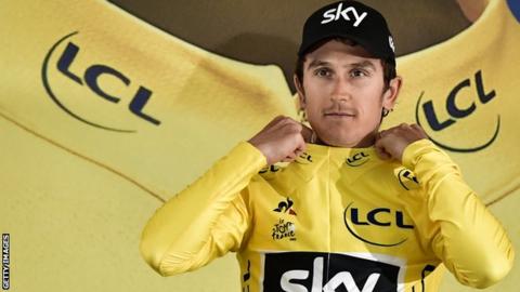 Geraint Thomas pulls on the yellow jersey after stage one of the 2017 Tour de France