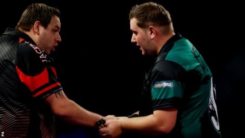Adrian Lewis congratulates Kevin Munch after losing in the first round of the PDC World Championship