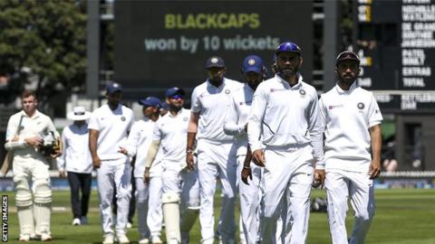 Virat Kohli leads a dejected India side off the field after their defeat by New Zealand