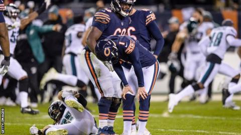 Disconsolate Chicago Bears kicker Cody Parkey puts his hands on his knees after missing a late game-winning field-goal attempt as Philadelphia Eagles players celebrates in the background