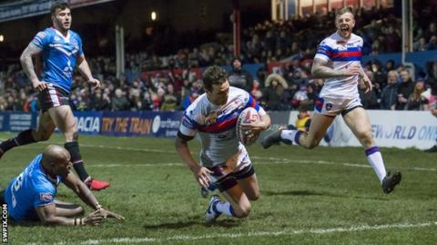 Scott Grix slides down for the first Wakefield try against Salford