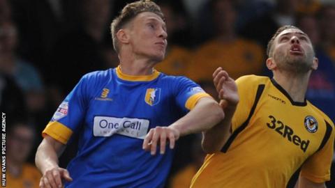 Martin Riley challenges Newport's Robbie Willmott