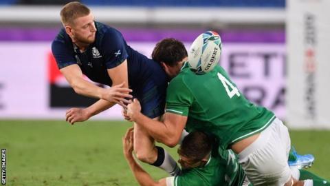 Finn Russell attempts an offload during Scotland's 27-3 defeat to Ireland in Yokohama