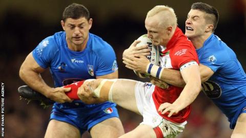 Wales' Rhys Evans is tackled by Italy's James Tedesco in the 2013 Rugby League World Cup