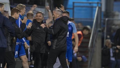 Peterhead boss Jim McInally celebrates at full-time with his bench