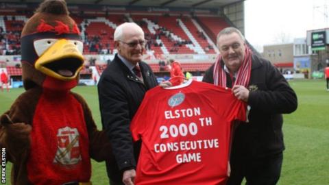 Derek Elston (right) receives a commemorative shirt