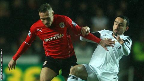 Cardiff City's Craig Bellamy in action against Leon Britton of Swansea City