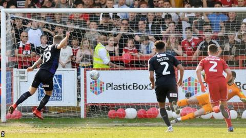 James Collins scores a penalty for Luton to put them 1-0 up at Accrington