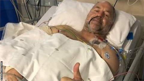 Naka Drotske giving a thumbs up from his hospital bed following the shooting