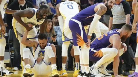 Golden State Warriors guard Stephen Curry was injured driving for the net in the third quarter against Phoenix Suns