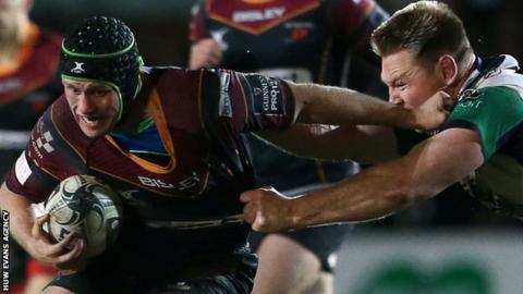 Newport Gwent Dragons' Nic Cudd is tackled by Tom McCartney