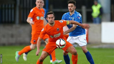 Linfield's Andrew Waterworth in action against Dave Montgomery of Dungannon
