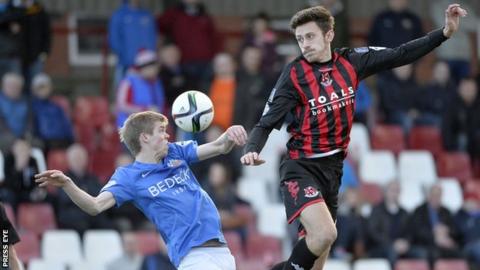 Glenavon's Rhys Marshall and Crusaders' Jordan Forsythe battle during the Premiership game in October
