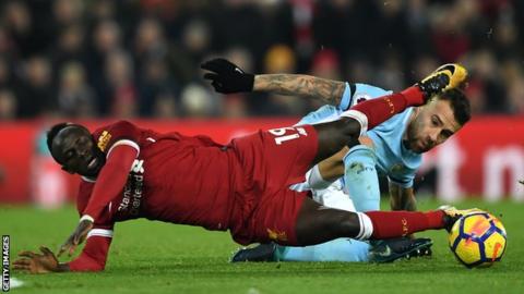 Sadio Mane challenges with Nicolas Otamendi