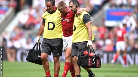 Gareth Anscombe being helped off at Twickenham