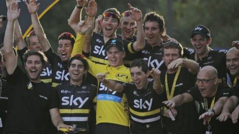 Chris Froome (in yellow) celebrates victory with Team Sky