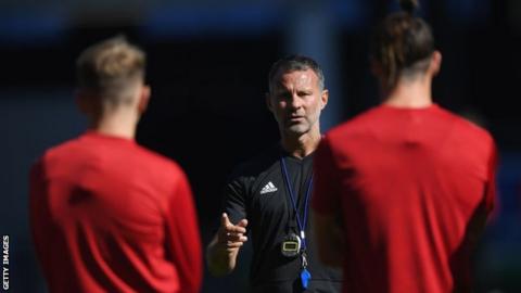 Wales manager Ryan Giggs talks to his players as he prepares for his first competitive game in charge