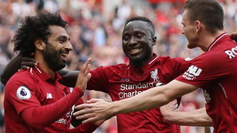 Liverpool's Mo Salah celebrates scoring with Naby Keita and Andy Robertson.