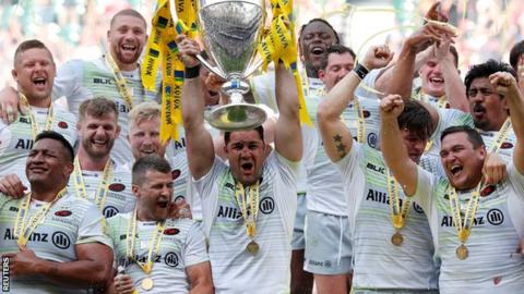 Saracens captain Brad Barritt lifts the Premiership trophy