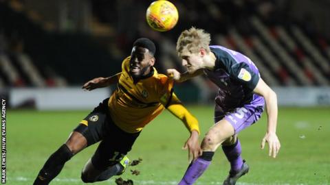 Jamille Matt of Newport County and Nathan Smith of Port Vale battle for the ball