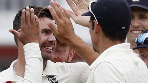 England players congratulate wicket-taker James Anderson