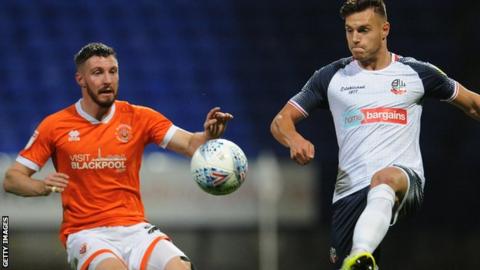 Bolton Wanderers' Dennis Politic (right) comes under pressure from Blackpool's James Husband
