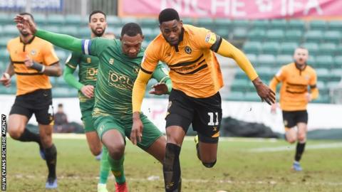 Jamille Matt of Newport County beats Krystian Pearce of Mansfield Town
