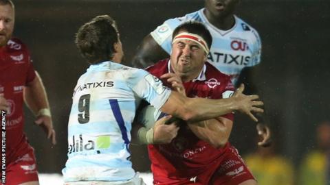Wyn Jones of Scarlets takes on Xavier Chauveau of Racing 92