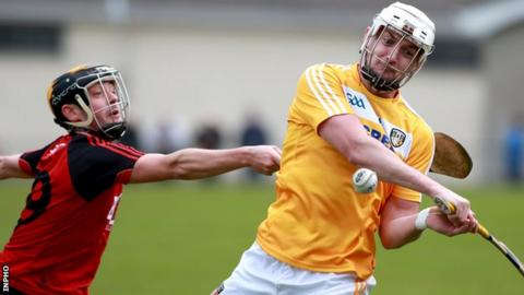 Down's Scott Nicholson challenges Conor McKinley in the Ulster derby encounter at Cushendall